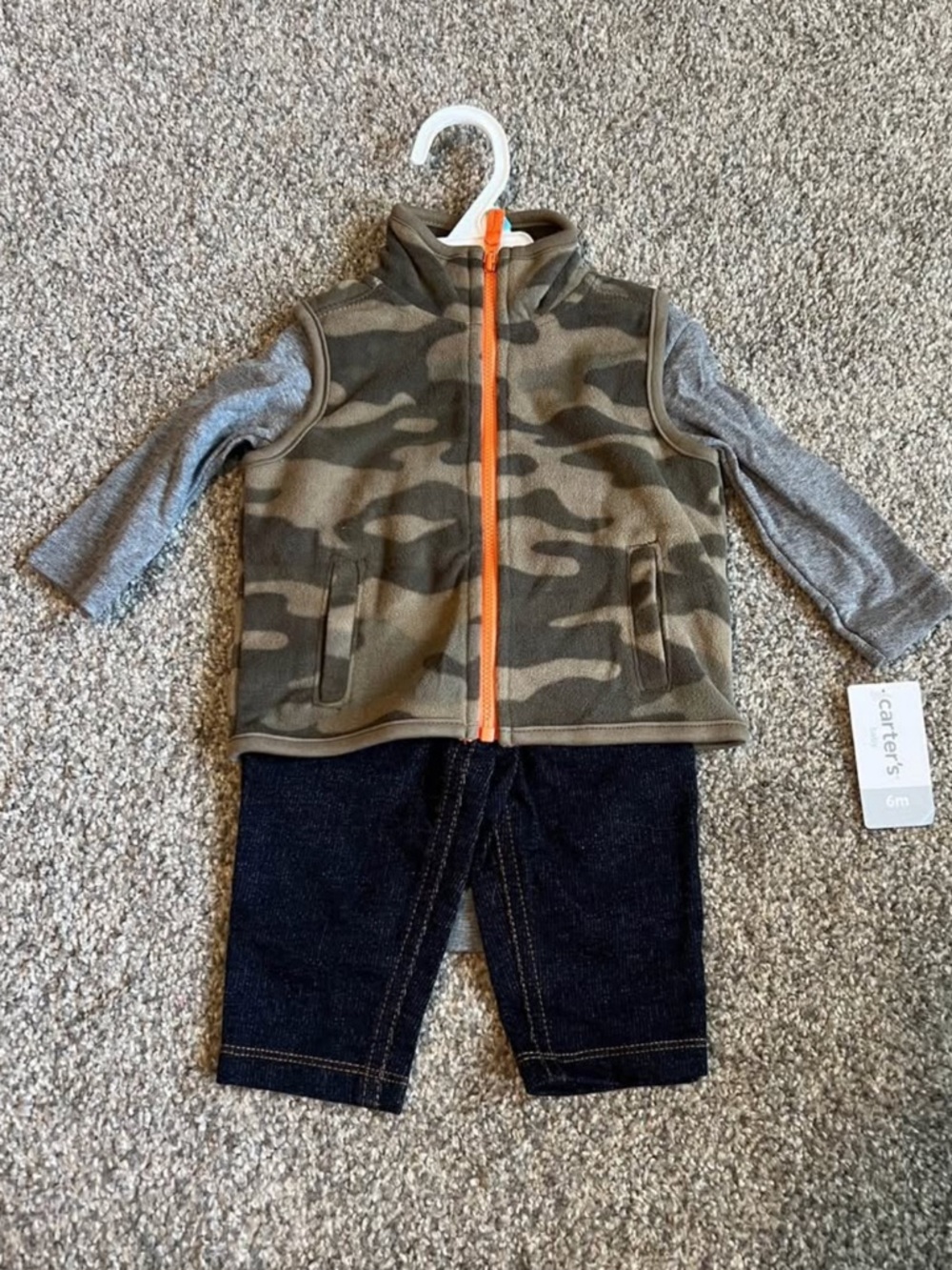 Carter's Grey Baby Clothing Tag on Neutral Carpet